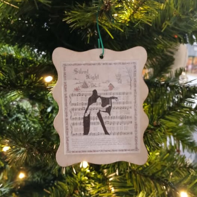 A handmade ornament on the giving tree from the 12 Days of Trees Gala.