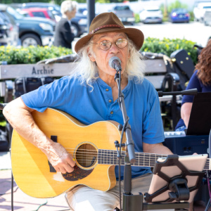 Sweet Bloods musician playing guitar at Fine Art Festival.