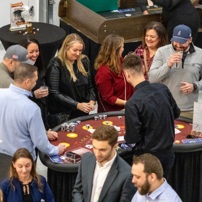 People playing games at casino night fundraiser.
